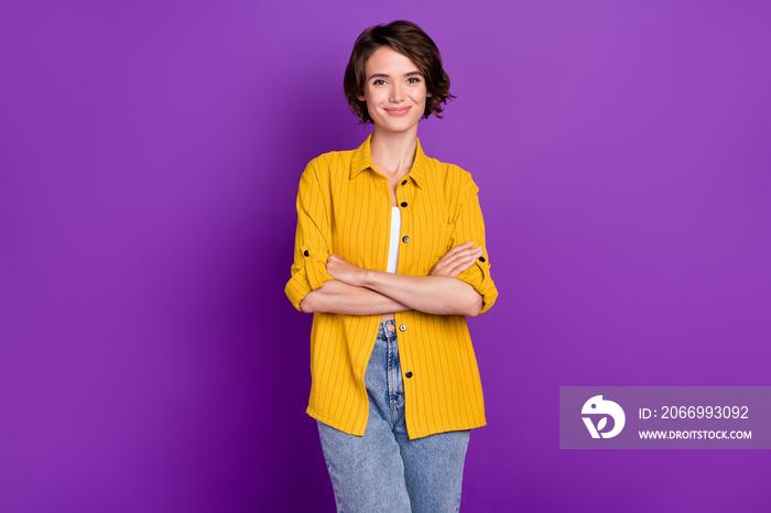 Photo of confident charming young lady wear yellow shirt arms crossed smiling isolated violet color background