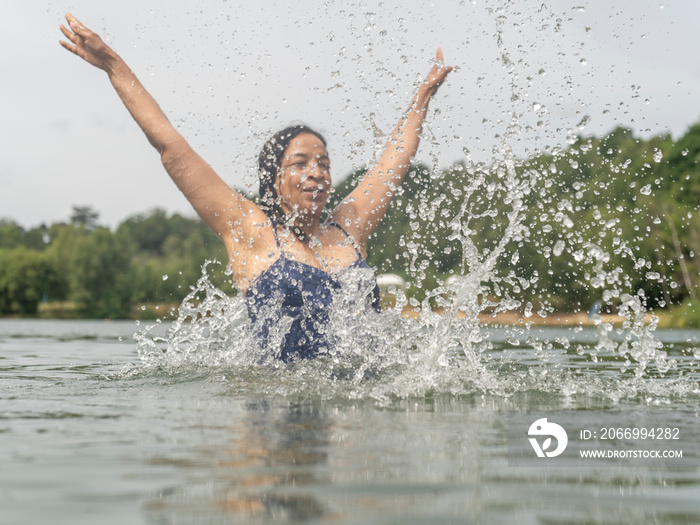 Woman splashing water in lake