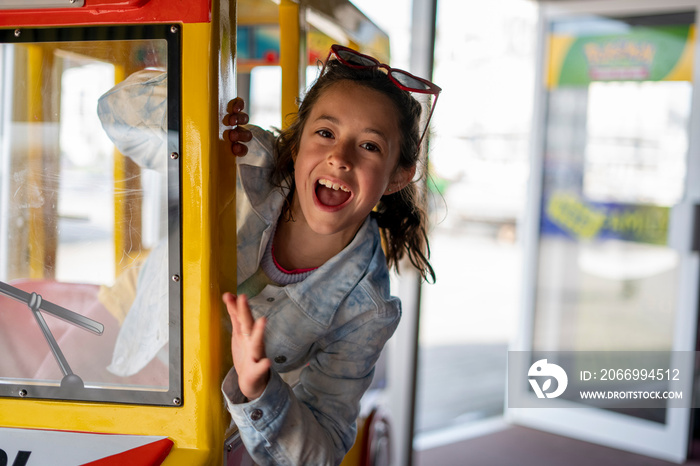 Portrait of girl (8-9) in amusement park ride