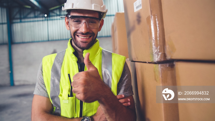 Professional industry worker close up portrait in the factory or warehouse . Production line operator or engineering looking at camera .