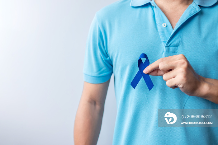 March Colorectal Cancer Awareness month, Woman holding dark Blue Ribbon for supporting people living and illness. Healthcare, hope and World cancer day concept