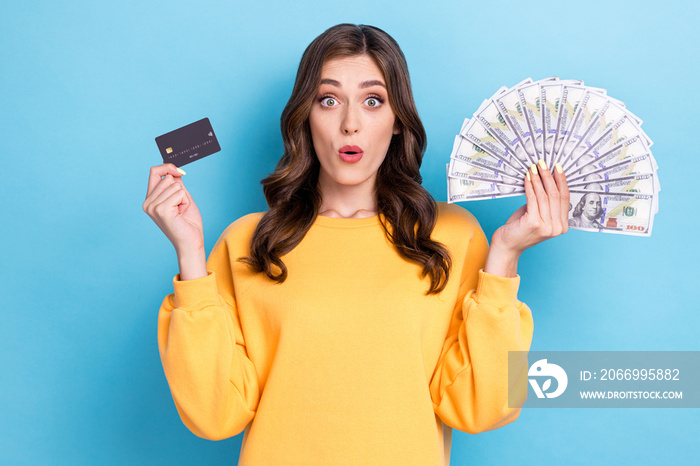 Closeup photo of young adorable pretty cute nice funny woman hold cash pouted lips credit card black friday surprised shopaholic isolated on blue color background