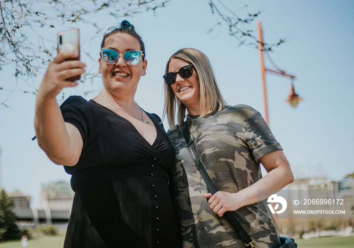 2 women take a selfie in the park