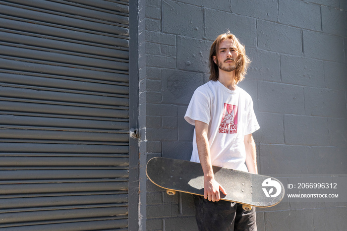 Portrait of young male skateboarder