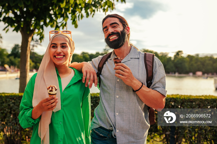 Arabic couple eating ice cream outdoors