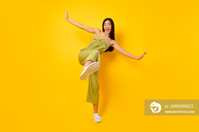 Full length photo of overjoyed cheerful vietnamese girl dance have good mood isolated on yellow color background