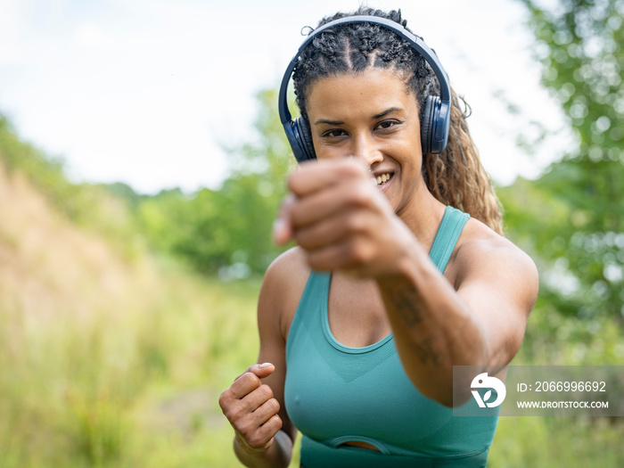 Portrait of woman exercising in meadow