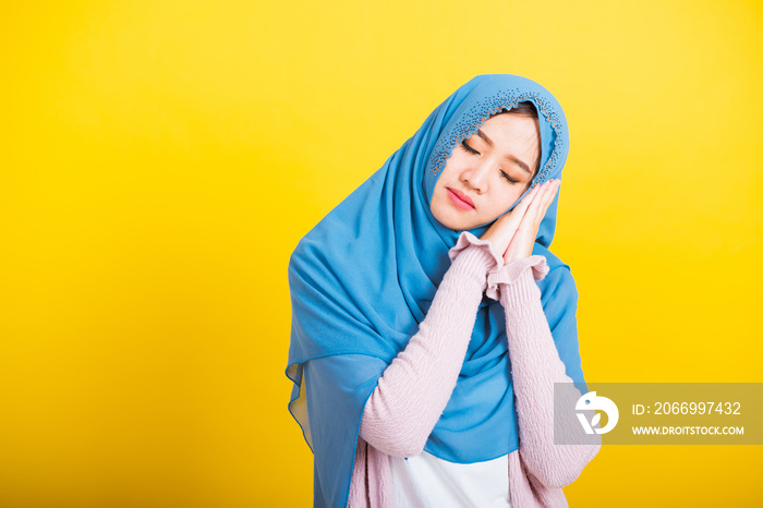 Asian Muslim Arab, Portrait of happy beautiful young woman Islam religious wear veil hijab funny smile she emotions tired sleepy her posing sleeping to dreaming with hands together near face, isolated