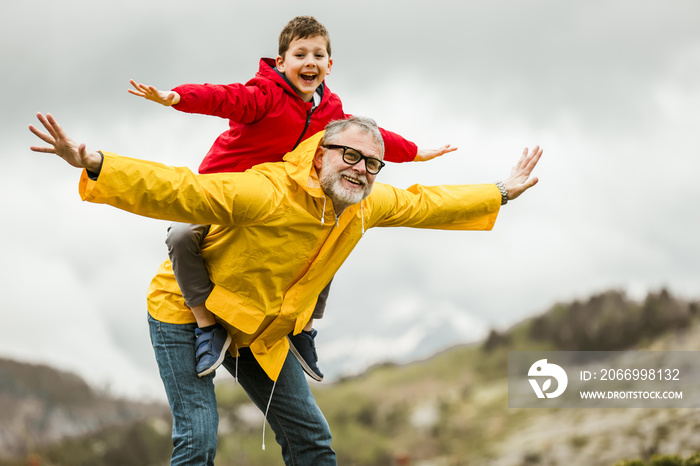 Father giving son piggyback ride outdoors