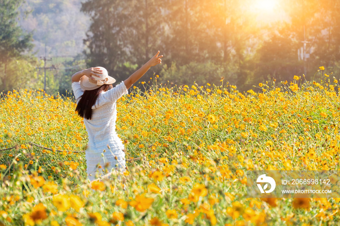 Asian women with blooming flower in the garden. Fresh spring and summer floral meadow. Natural moment and back to nature for peace and serenity.