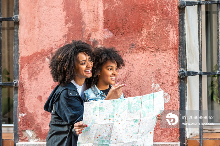 Mother and Daughter Using a Map in the Street.