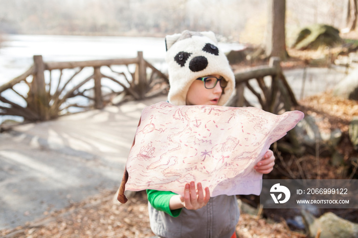 Girl (8-9) holding map