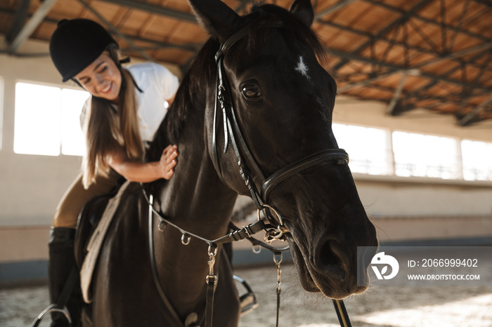 Beautiful woman wearing hat with horse