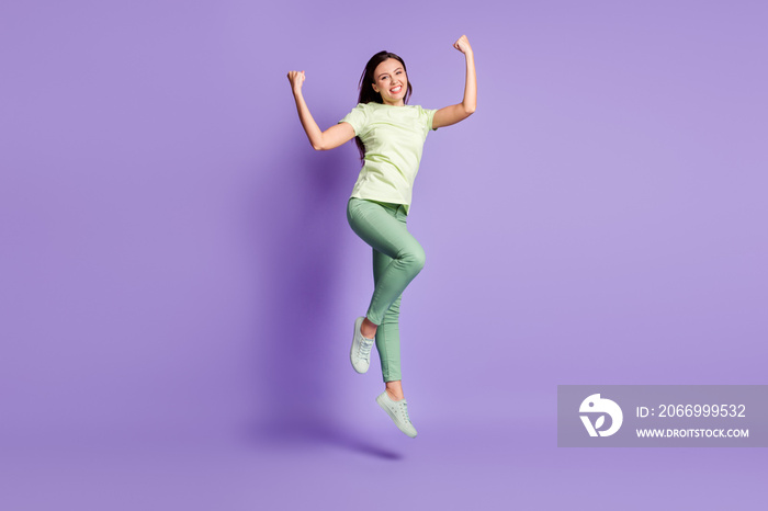 Full size portrait of delighted person jumping fists up toothy smile success isolate don purple color background