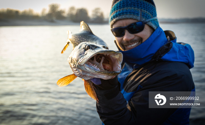 Fisherman and trophy Pike. Fishing background.