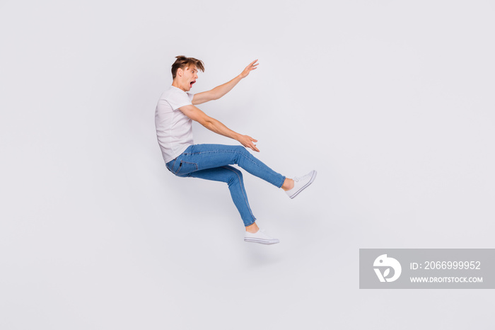 Full length photo of terrified guy flown away with stormy wind wear casual outfit isolated white background