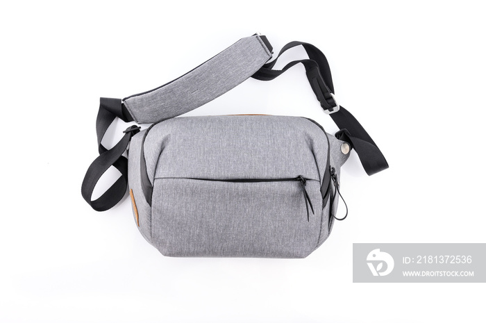 Top view of  gray fashionable sling bag or Waist bag isolated on white background.