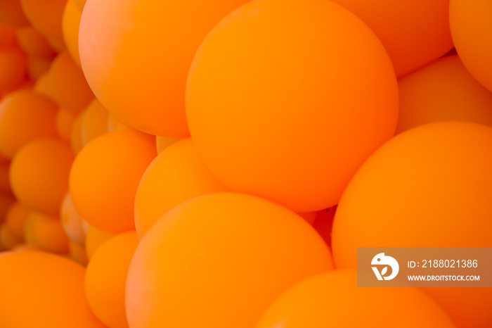 Festive composition with bunch of matte orange balloons. Macro shot, close up, background with a lot