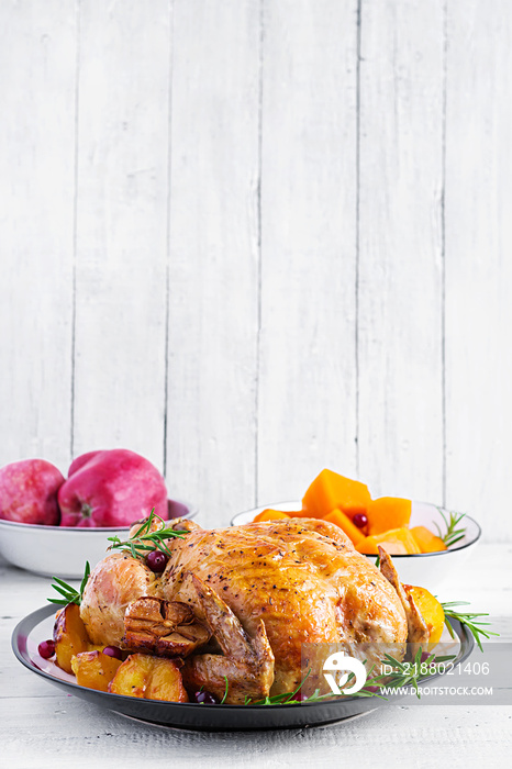 Roasted turkey garnished with cranberries on a rustic style table decorated  autumn leaf. Thanksgivi