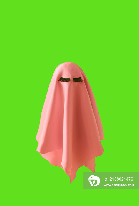 Pink ghost with lashes on a neon green background. Halloween scary background cosmetic concept. Mini