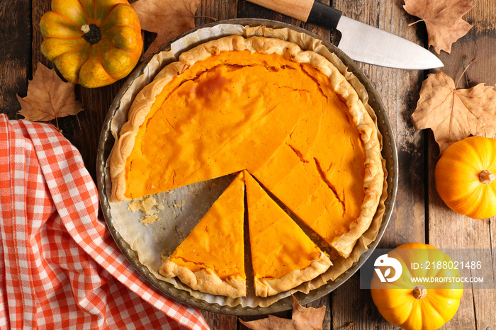 pumpkin pie on wood background