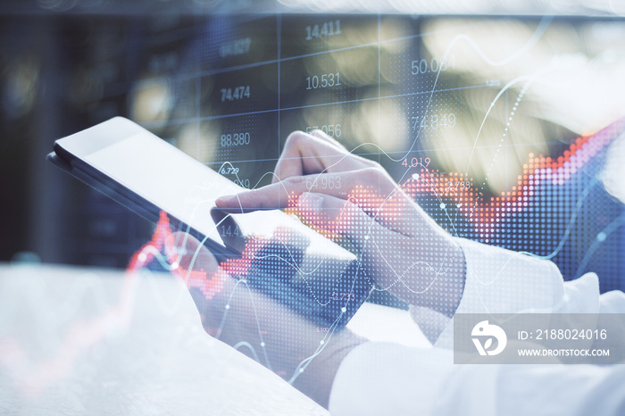 Close up of businessman hand using tablet with abstract red forex chart index on blurry outdoor back