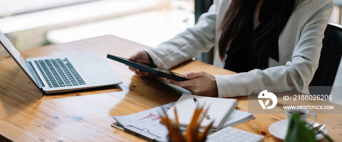 Businesswoman hand using digital tablet in office. female entrepreneur reading news on social media 