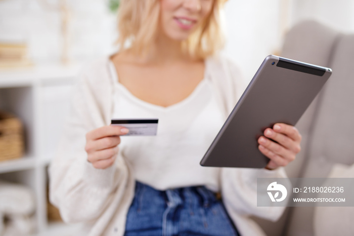 tablet pc and credit card in female hands