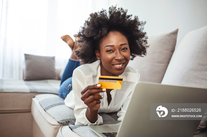 Shot of an attractive young woman making payments online with a credit card. Satisfied woman relaxin