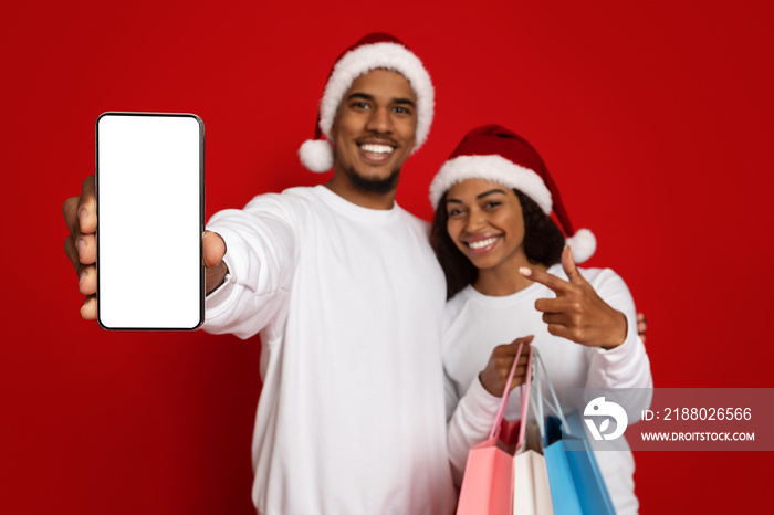 Happy black couple shopping online, using cellphone, mockup