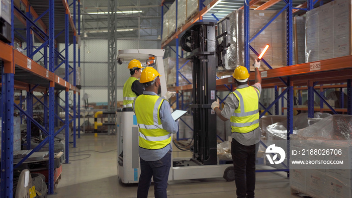 Teamwork of black workers working in large warehouse store industry.Rack of stock storage. Interior 