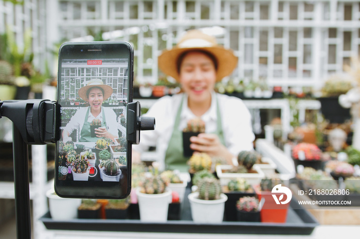 Young Asian woman SME small business entrepreneur live selling cactus in online social media platfor