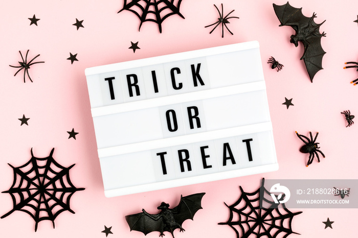 Halloween flat lay of lightbox with Trick or treat text and decoration
