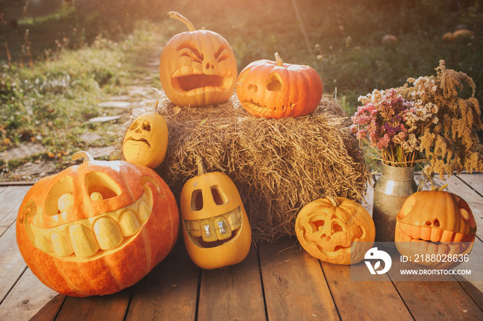 Ghost pumpkins on Halloween. Рead Jack on an autumn background. Holiday outdoor decorations