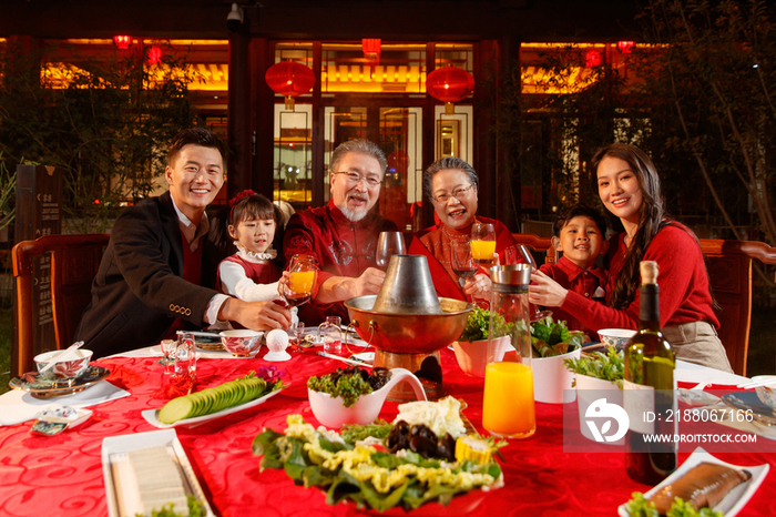 东方家庭在中式庭院内干杯庆祝新年