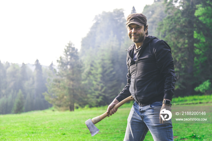 a portrait of an urban man, migrated to a village farm, he is preparing for wood chopping