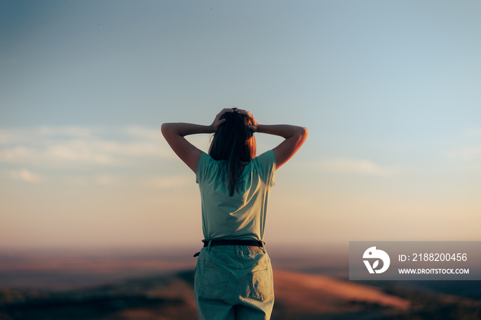 Woman Looking Amazed at Mind-blowing Scenery in Sunset Hour. Traveler feeling disoriented and lost on a mountain top