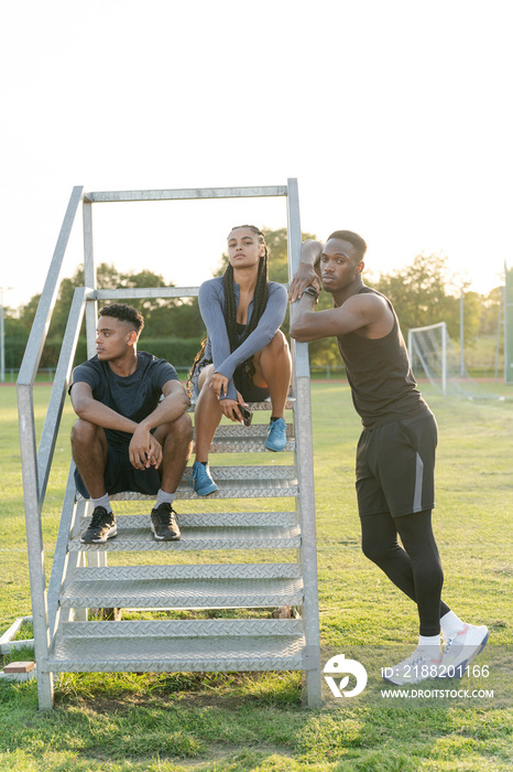 Group of athletes sitting on steps at stadium