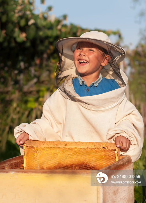 Beekeeper a young boy who works in the apiary. Beekeeping.