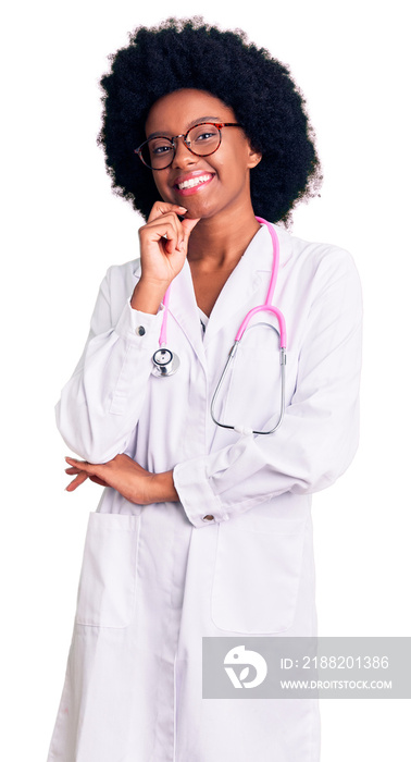 Young african american woman wearing doctor coat and stethoscope looking confident at the camera smiling with crossed arms and hand raised on chin. thinking positive.