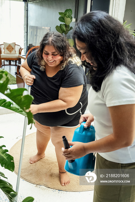 Group of housemates cleaning their home together