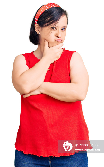 Brunette woman with down syndrome wearing casual clothes thinking looking tired and bored with depression problems with crossed arms.