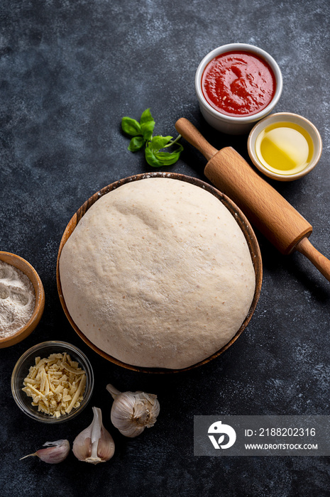 Raw dough with ingredients for cooking pizza. Sourdough pizza, baking at home