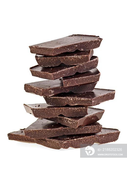 Heap of black chocolate bars on a white background. Close up of chocolate pieces.