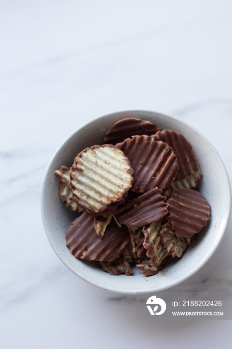 Japanese chocolate potato chips on a marble background with copy space