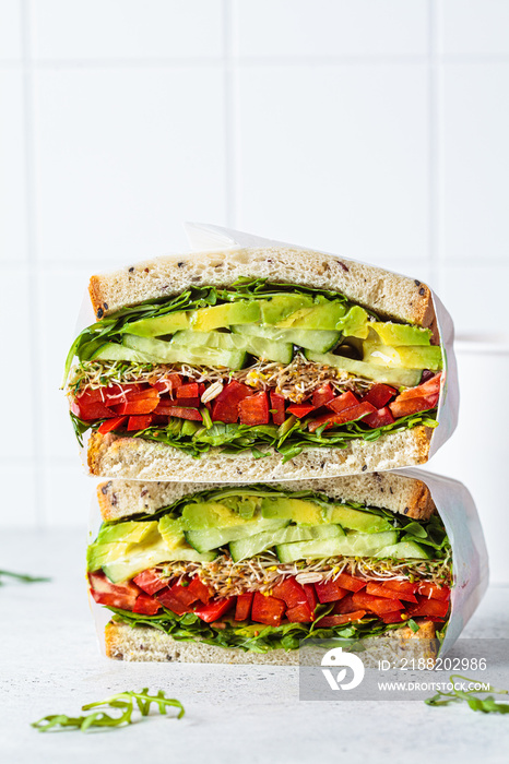 Vegetable sandwich in paper wrap. Vegan healthy food, takeaway food.