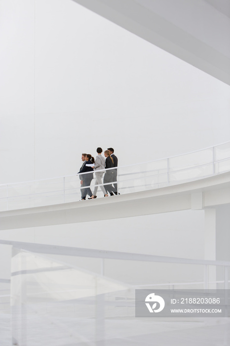 Business people walking on modern balcony