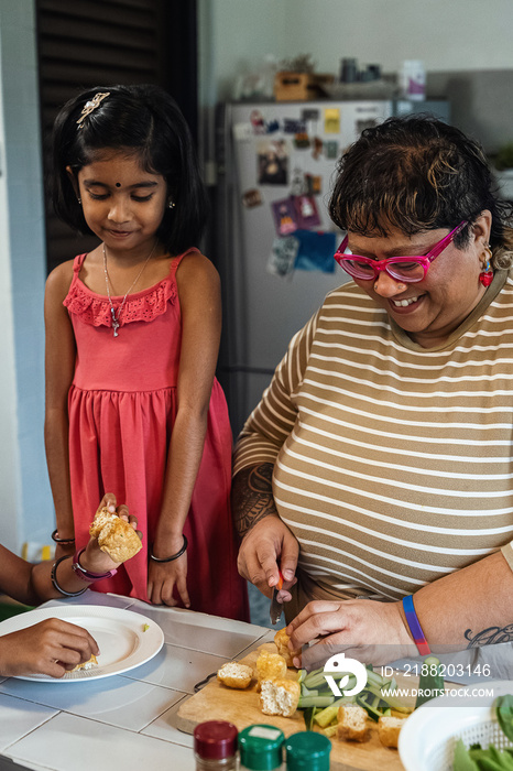 Kids helping their parent cook a healthy meal for the family dinner at home