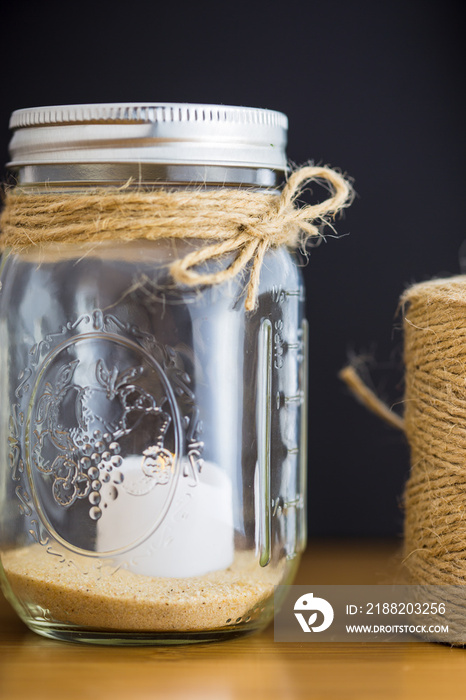 Decorative glass jar with twine spool