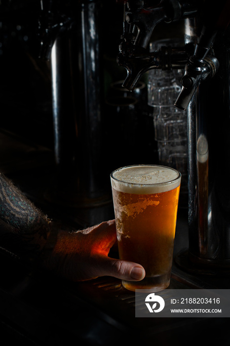 Full beer poured on bartop - tall vertical shot